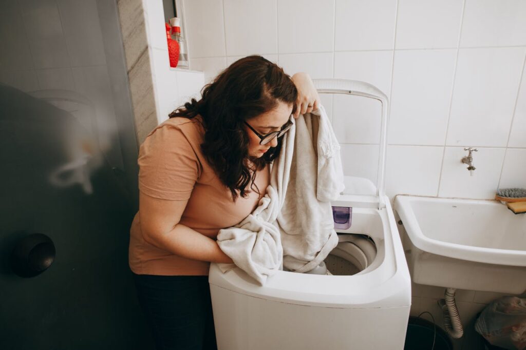 Woman washing clothes in a washing machine